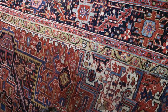 A Persian Heriz red ground carpet, 380 x 280cm, worn